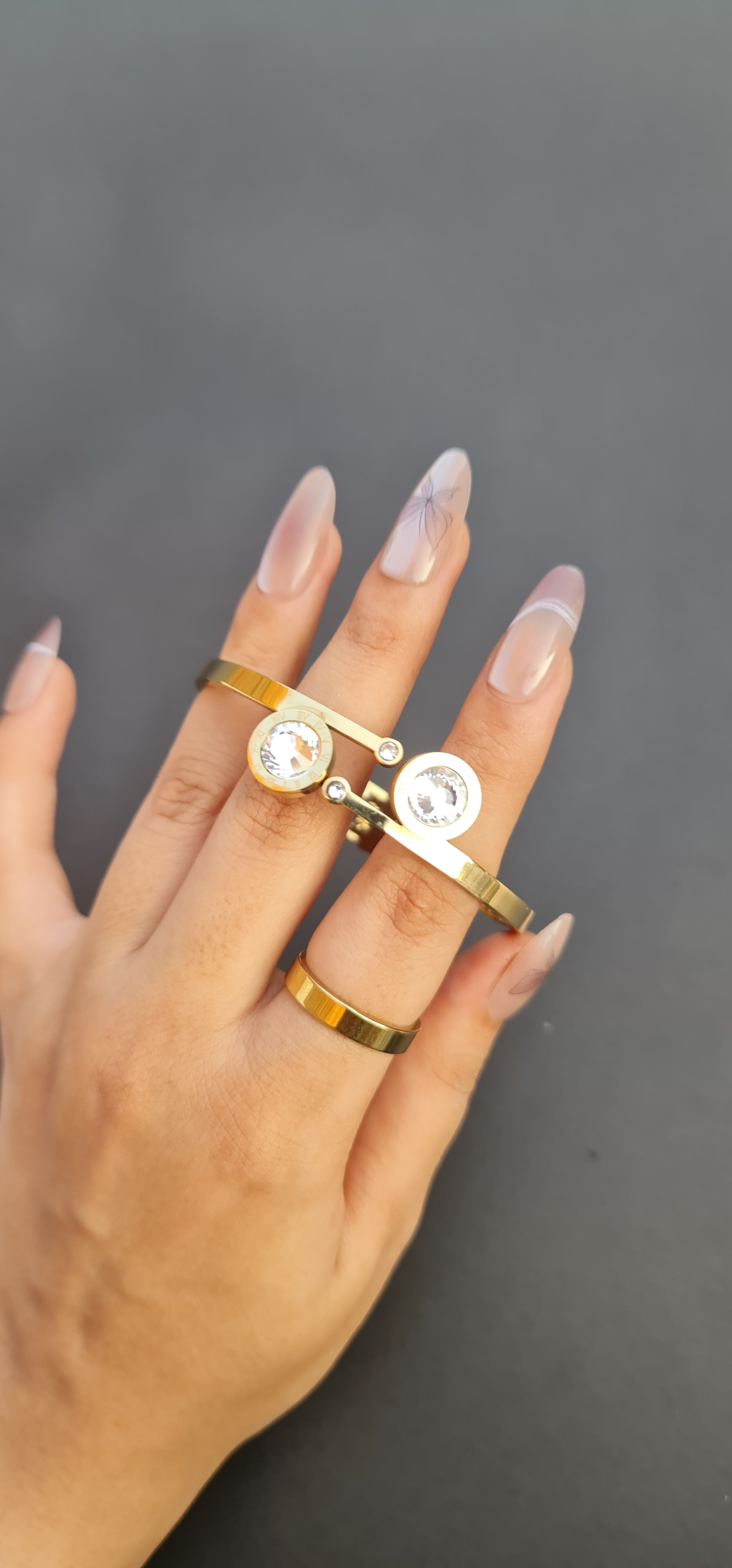 Gold-Toned Stainless Steel Bangle with Roman Numerals and Crystals